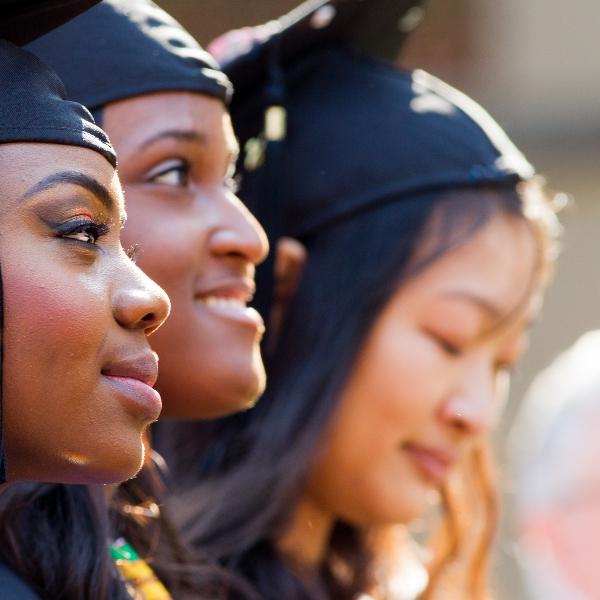 Three graduates in caps and gowns